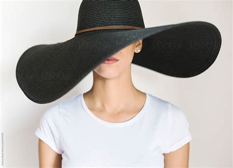 Young Woman Wearing A Big Black Hat By Stocksy Contributor Simone