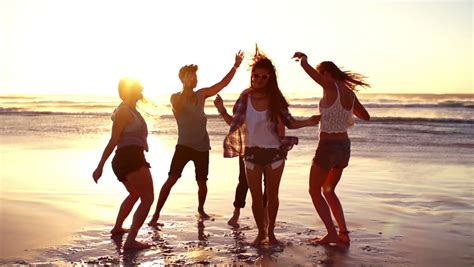 Friends Dancing On Beach In Sunset Stock Footage Video