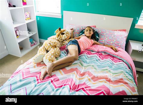 Tween Girl Relaxing On Her Bed In Her Bedroom Stock Photo Alamy