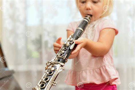 A Little Girl Plays The Clarinet Teaching Children Music At A Music