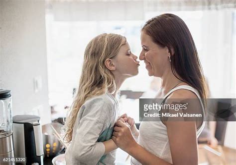 mother kissing daughter lips photos and premium high res pictures getty images