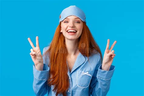 Happy And Carefree Feminine Young Redhead Female In Nightwear Sleep Mask And Pyjama Laughing