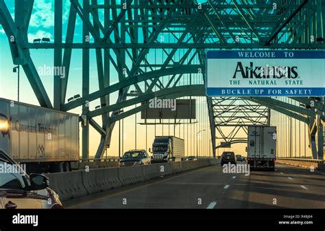 Traffic At Sunset On The Hernando De Soto Bridge Over The Mississippi
