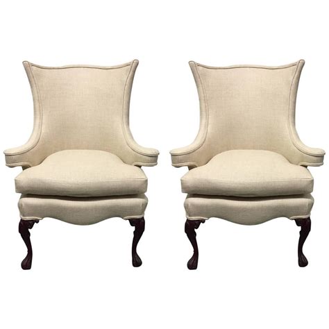 A queen anne wingback chair with cabriole legs. Pair of Queen Anne Style Wingback Chairs For Sale at 1stdibs