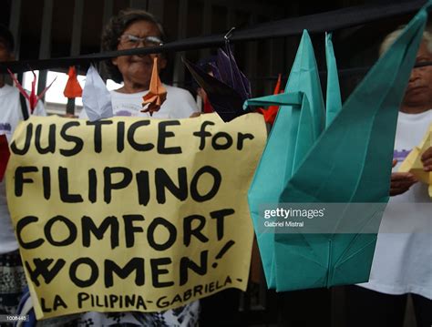 An Origami Dove Sits Next To A Banner Claiming Justice For Filipino