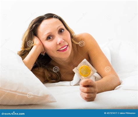 Adult Woman Holding Condom In Bed Stock Image Image Of Face Sheath
