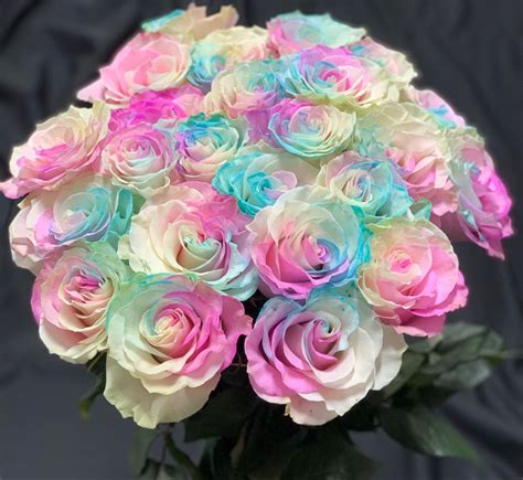 A Bouquet Of Multicolored Roses In A Vase On A Black Background With