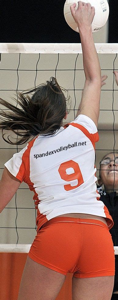 Two Women Are Playing Volleyball On The Court