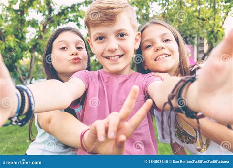Happy Best Friends Kids Taking Selfie Outdoors At Backyard Party Stock