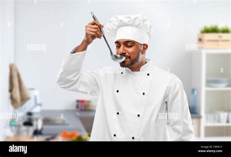 Cooking Profession And People Concept Happy Male Indian Chef In Toque Tasting Food From Ladle