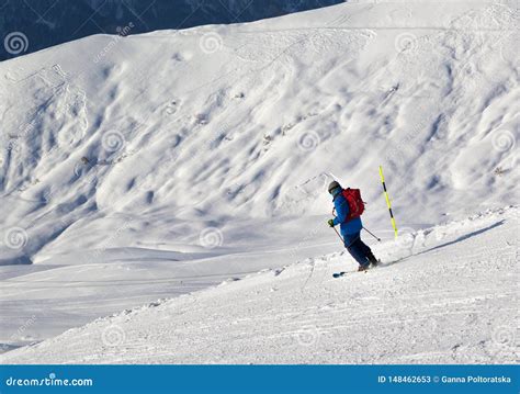 Skier Downhill On Snowy Ski Slope In Cold Sunny Evening Stock Image