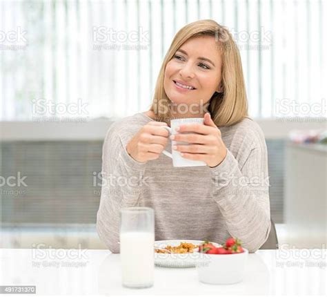 Beautiful Woman Eating Breakfast At Home Stock Photo Download Image