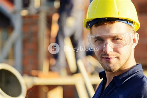 Male Construction Worker Smiling At A Building Site Royalty Free Stock