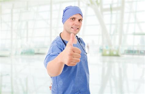 Happy Male Doctor Showing Thumbs Up Photo Background And Picture For