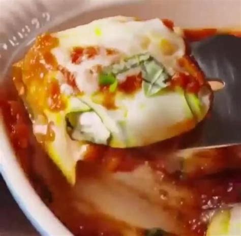 Make the raviolis by laying four zucchini strips in a star pattern, drop a scoop of filling in the center, and wrap the zucchini strips into a small bundle around the filling. Keto zucchini ravioli, credits and typed recipe in ...