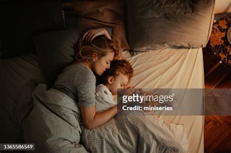 Loving Mother And Daughter Sleeping Together In Bed In The Evening High