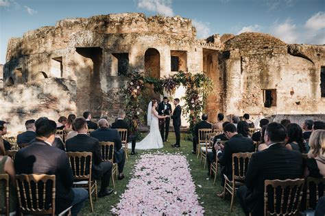 A Bride And Groom Standing At The End Of Their Wedding Ceremony In