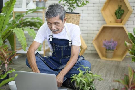 Happy Senior Asian Retired Man With Laptop Is Relaxing And Enjoying