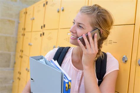 Female Student Using Mobile Phone In Locker Room At College Stock Photo Image Of Connection