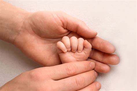 A Newborn Holds On To Momand X27s Dadand X27s Finger Hands Of Parents
