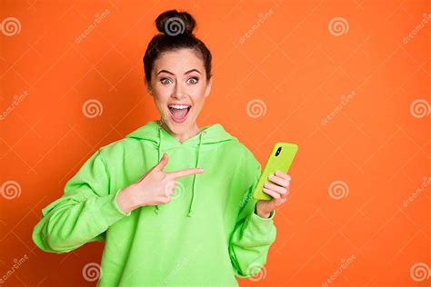 Photo Portrait Of Excited Girl Pointing Finger At Phone In Hand Open