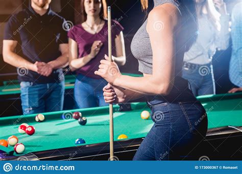 Young Woman Playing In Billiard Posing Near The Table With A Cue In Her Hands Stock Image
