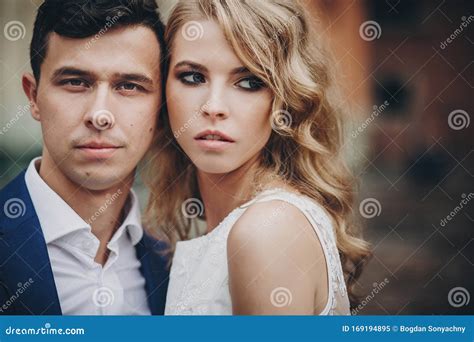 Portrait Of Stylish Couple Embracing In European City Street Sensual Romantic Moment Stock