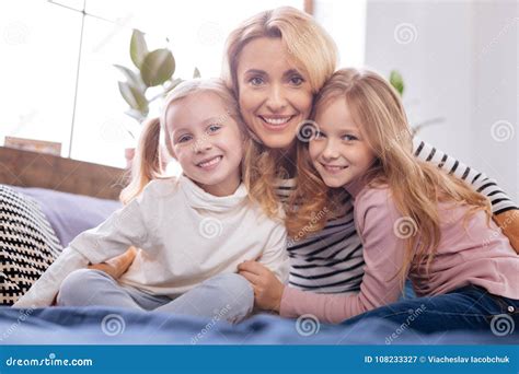 happy mother and her daughters embracing stock image image of fosterage enjoyment 108233327