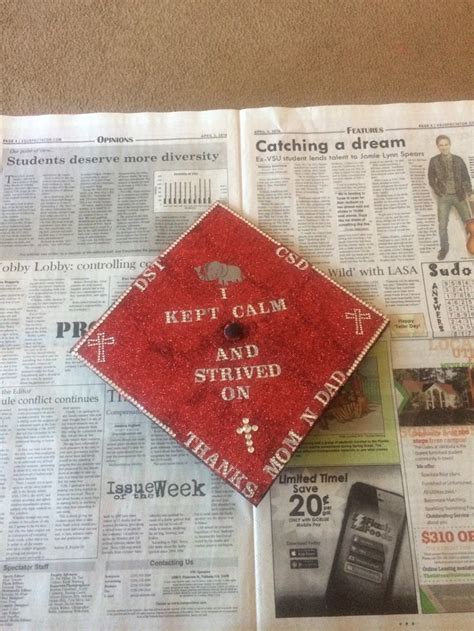 A Red Graduation Cap Sitting On Top Of A Newspaper