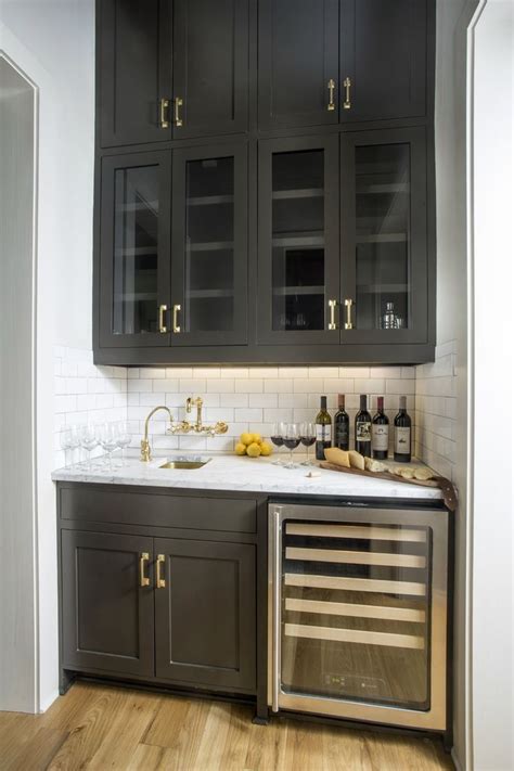 Black wet bar + wine fridge + white subway tile backsplash + black