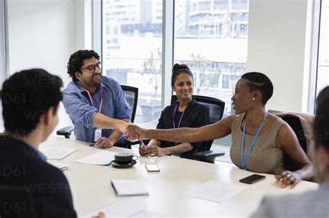 Business People Shaking Hands In Conference Room Meeting Stock Photo