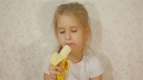 Young Girl Eating Banana Sitting At Home Stock Video Footage 0028 Sbv