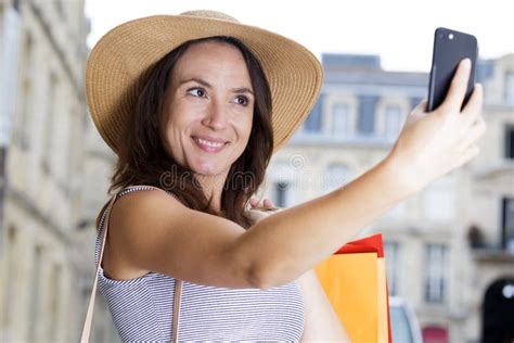 Happy Woman Taking Selfie With Peace Sign On City Street Stock Image