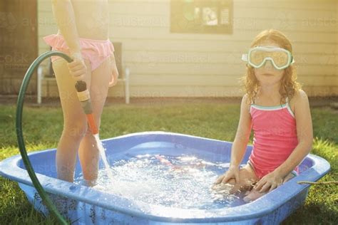 Image Of Two Girls Playing In A Wading Pool Austockphoto