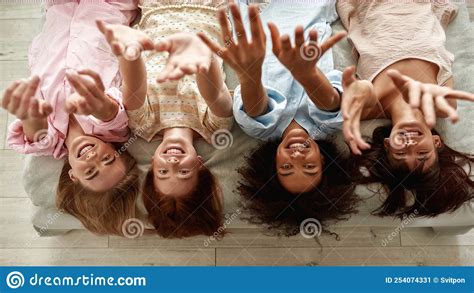 Top View Of Multiracial Girls Pull Hands Up On Bed Stock Image Image Of Multiracial Interior