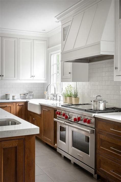 Two Toned Kitchen With White Upper Cabinets And Wood Stained Lower