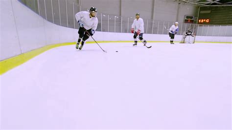 The puck is dropped in the center ice at the start of the game. Hockey player leads the puck during the ice hockey match Stock Video Footage - Storyblocks