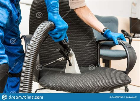If your chair is old and smelly, your best bet is to call a professional cleaner and give it for their dry cleaning service. Young Man In Workwear And Rubber Gloves Cleans The Office ...