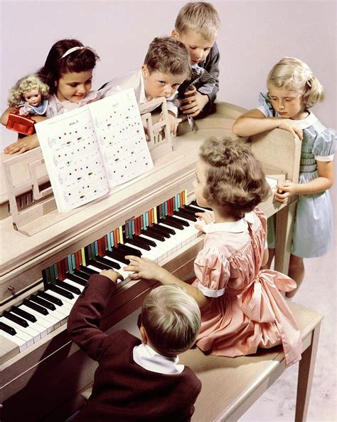A Group Of Children At The Piano By Herbert Matter