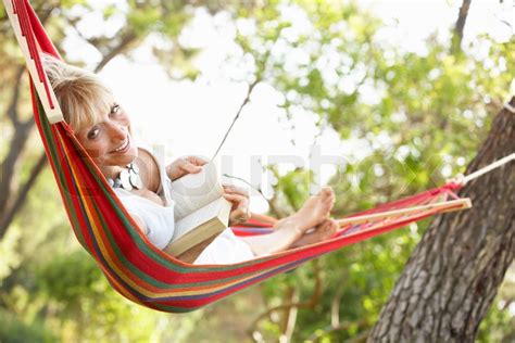 Senior Woman Relaxing In Hammock Stock Image Colourbox