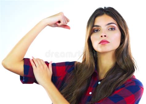 Just Look At These Guns A Young Woman Flexing Her Muscles Against A