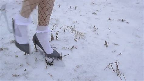 Russian model in high heels actively kneads the dirt with her heels. High heels and frilly white socks in the snow - YouTube