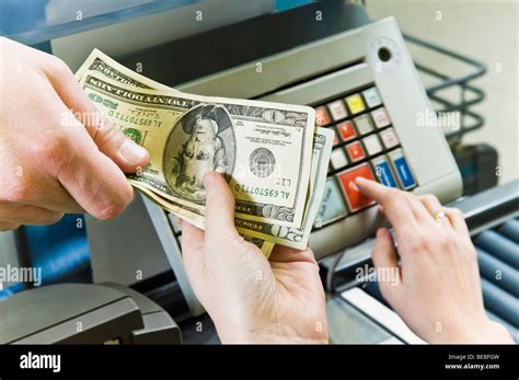 Customer Paying To Cashier Stock Photo Alamy