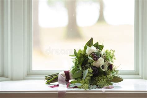 Wedding Bouquet With Vintage Ribbon On A Window Sill With Shallow Depth