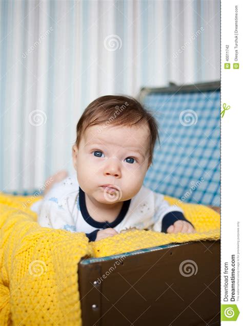 A Cute Baby Lying On Yellow Knitted Wrap Stock Photo Image Of