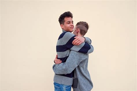 Premium Photo A Young Interracial Gay Couple Hugging Isolated On A