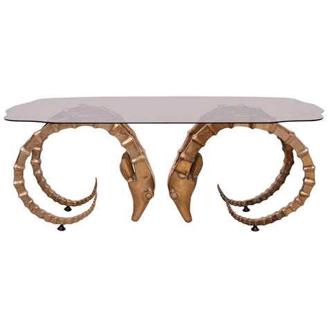 Iconic pair of brass rams heads or ibex made in the manner and the style of alain cheruet. Brass and Glass Ram's Head or Ibex Coffee Table in the ...