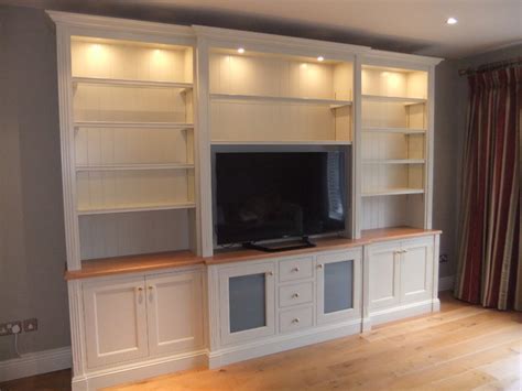 Style includes elegantly tapered legs, grooved sides, molded crown edged table top and brushed nickel rounded square knobs; Hand painted living room storage cabinet.