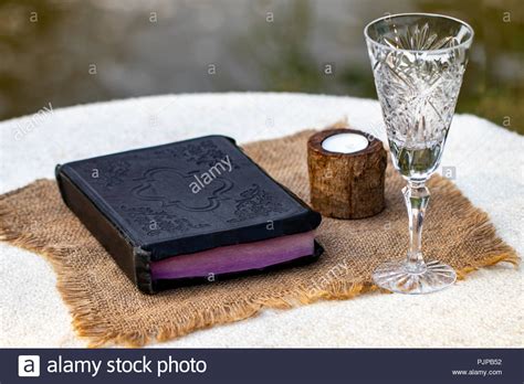 Taking Communion Cup Of Glass With Red Wine Bread And Holy Bible On