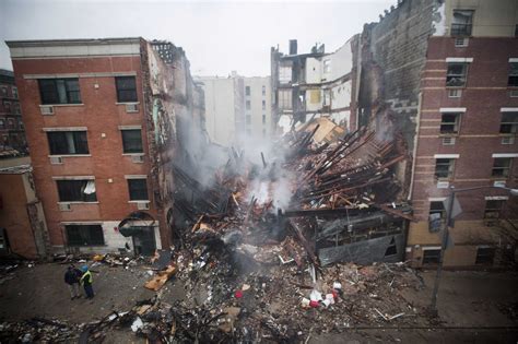 New York City Firefighters Work At The Site Of A Building Explosion And Collapse In The Harlem